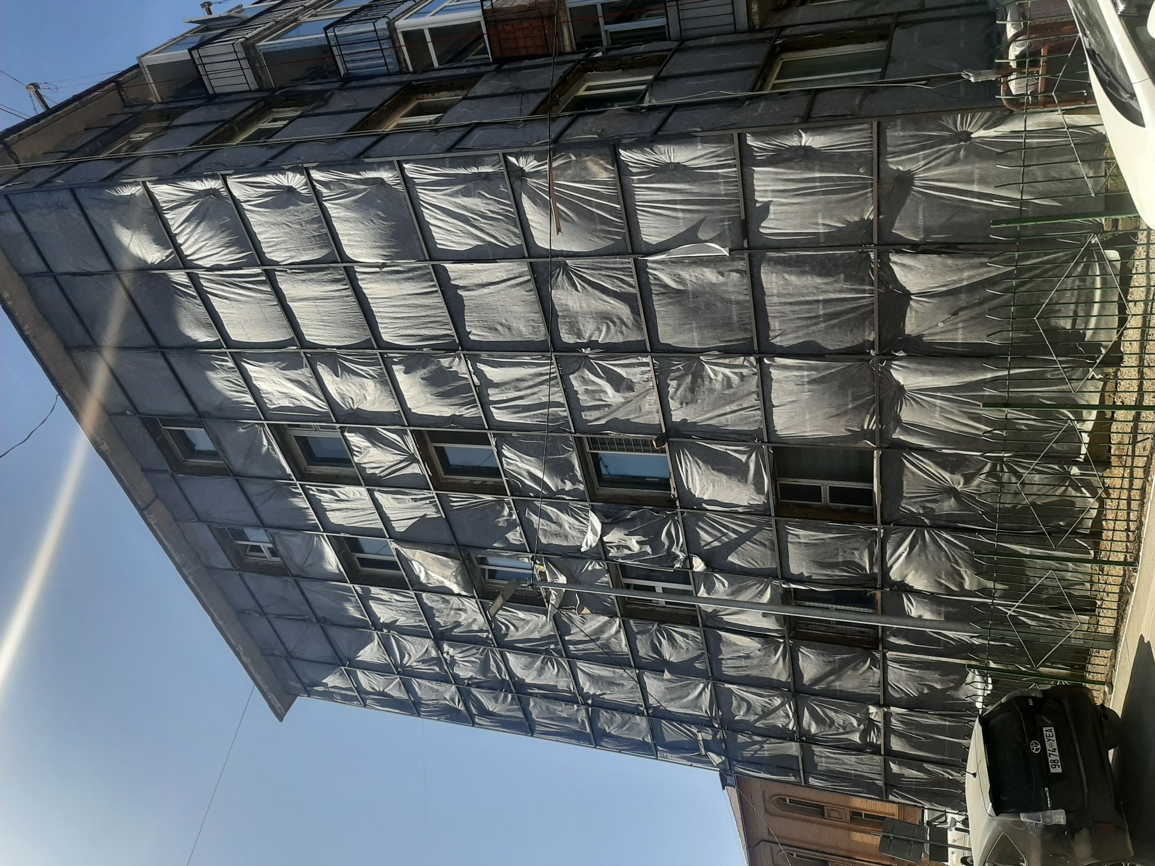 Precast panel building with unfinished insulation at external walls. 