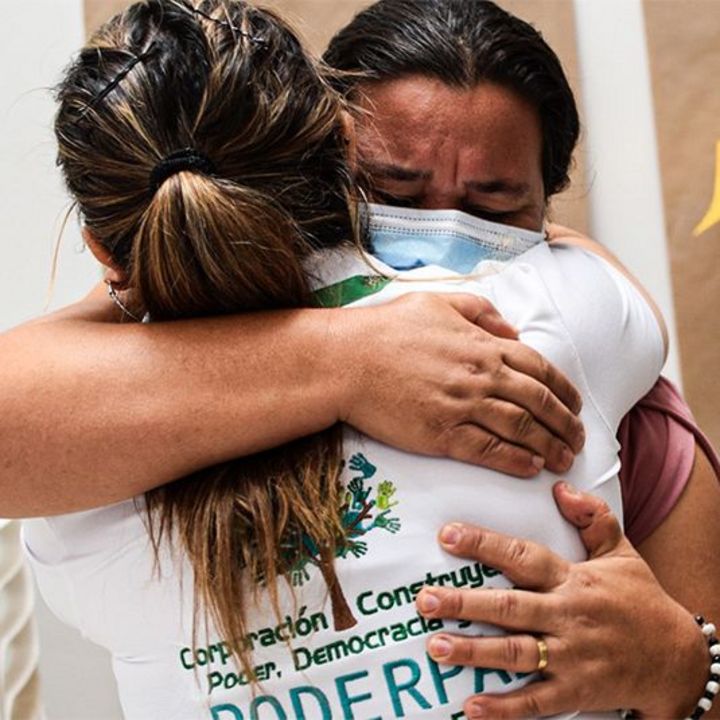 Two women hugging each other during a workshop for the ProPaz II Project in Colombia.