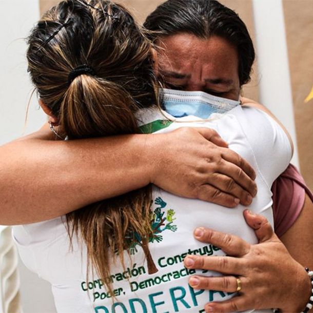 Two women hugging each other during a workshop for the ProPaz II Project in Colombia.