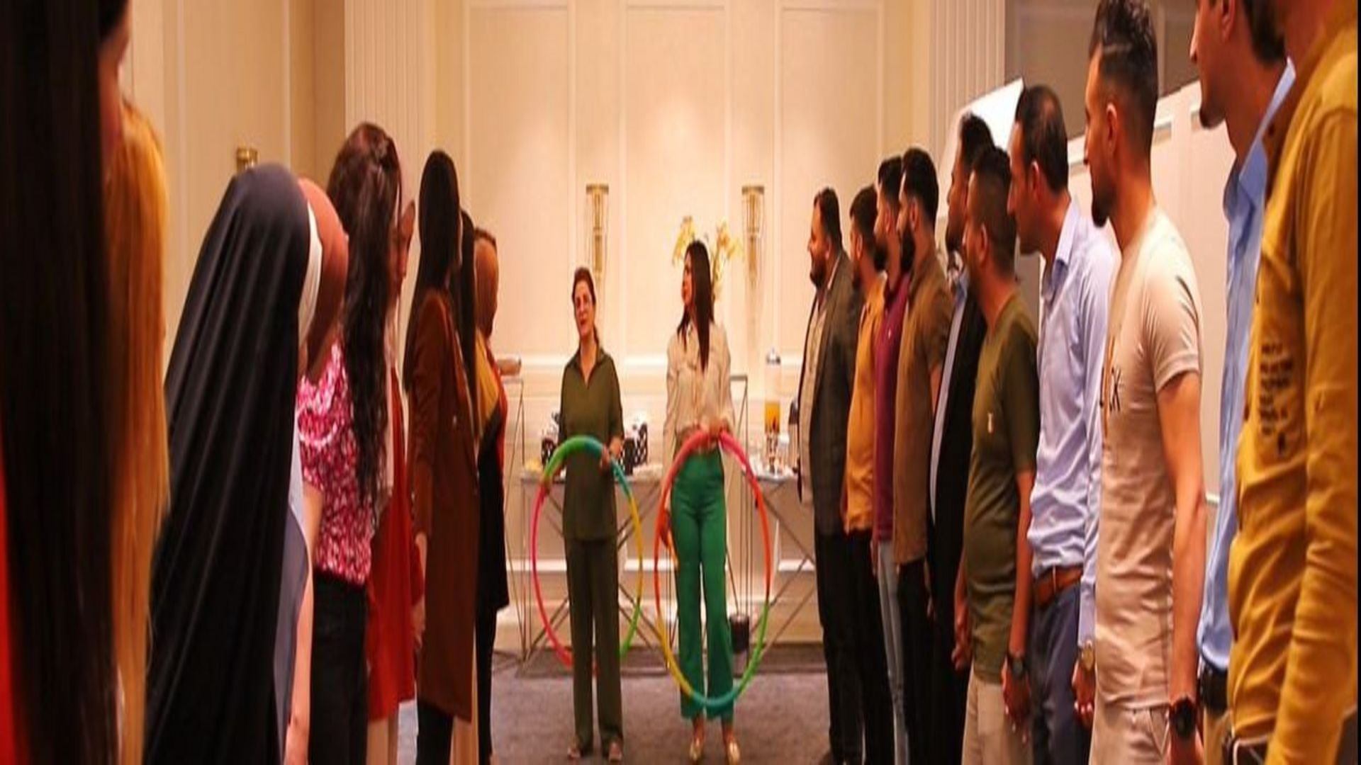 A group of young people in in a big room while participating at an interactive training session.