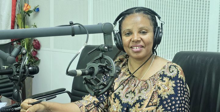 Female radio moderator on the microphone.