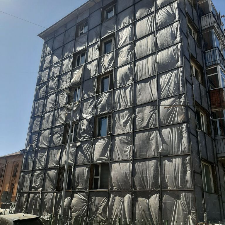 Precast panel building with unfinished insulation at external walls.