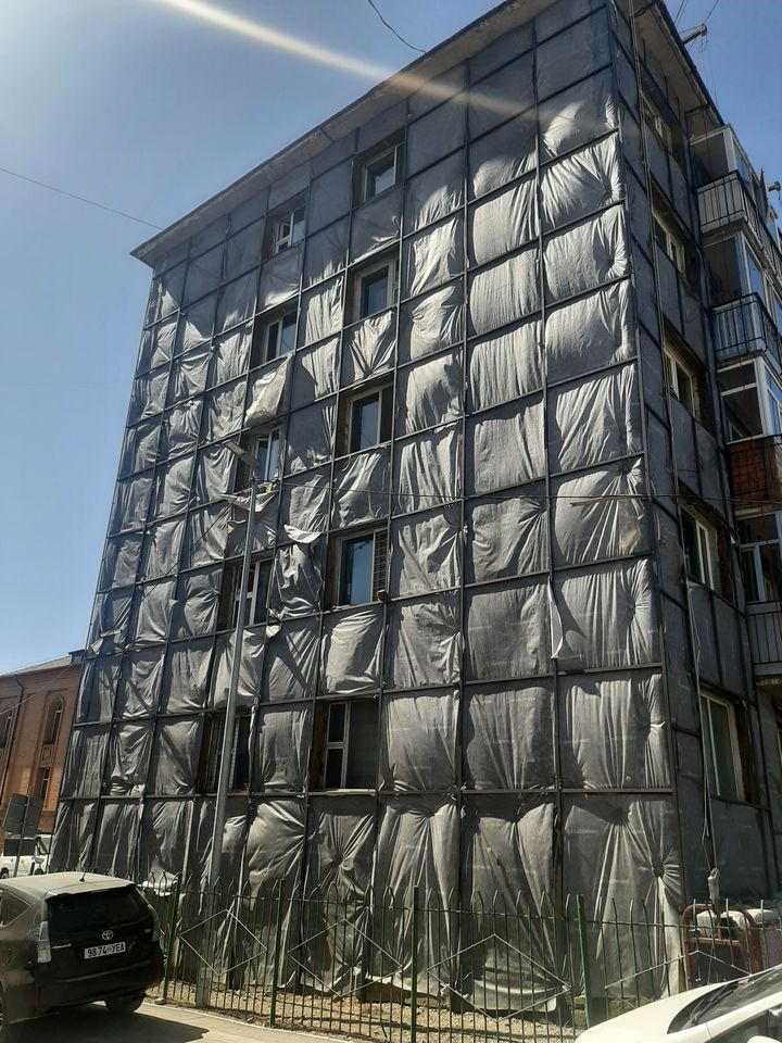 Precast panel building with unfinished insulation at external walls.