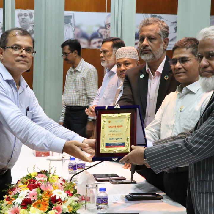 A group of men from the National Local Government Day of Bangladesh is handing over a certificate to the CReLIC team leader.