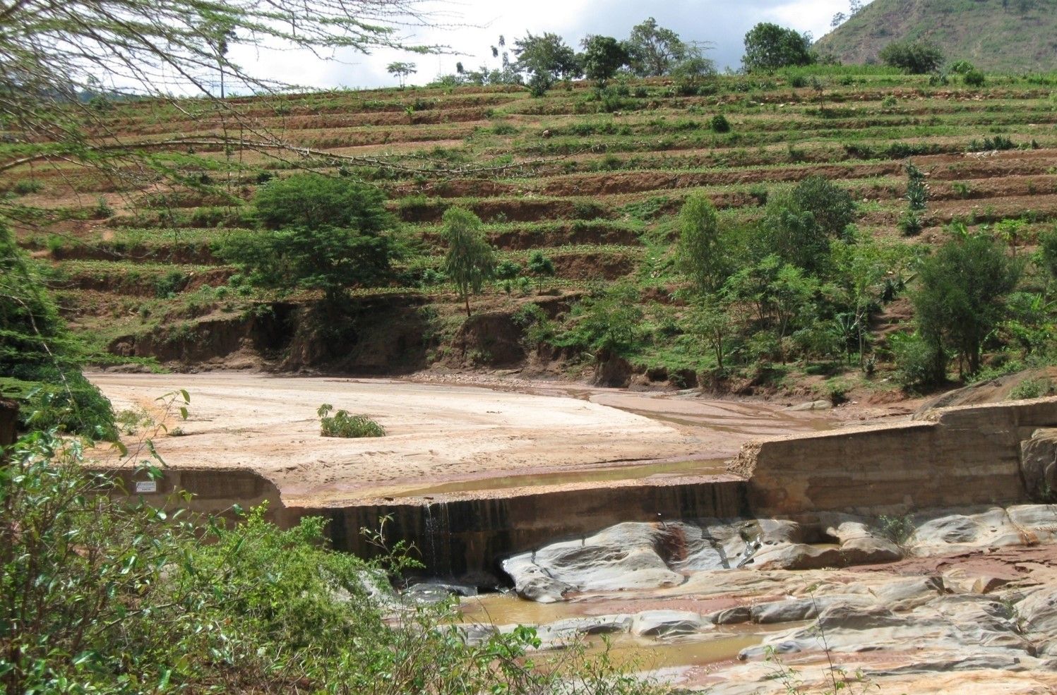 Sand dam with terrace farming in the background.
