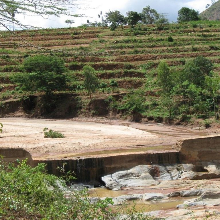 Sand dam with terrace farming in the background.